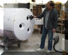 Chuck Hards holds one of the three vent fans that will be installed in the three holes visible in the tailpiece. 24 OCT 2001