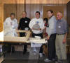 Nate Goodman, Patrick Wiggins (holding the tertiary mirror which was donated by Chuck Hards), Steve Dodds (holding the 25 cm 3x secondary mirror), Siegfried Jachmann and Mark Bloomenthal admire the new optics.  11 DEC 2004